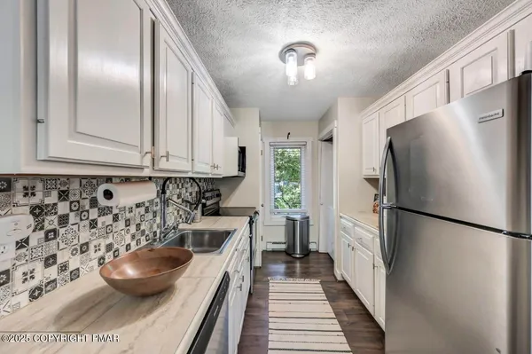 a view of washer and dryer with kitchen view