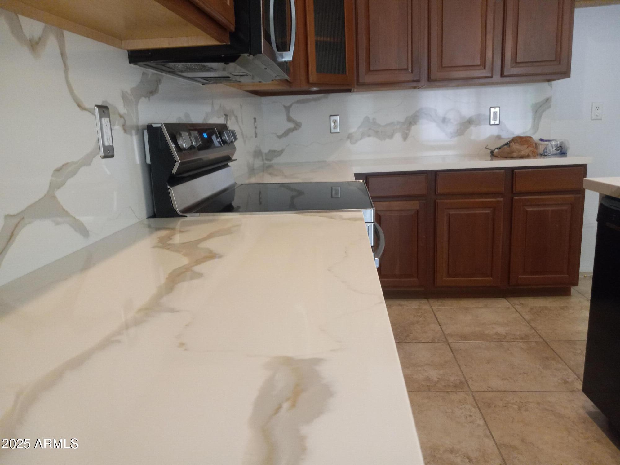 3947 West Roundabout Circle Chandler, AZ 85226 - Photo 16 of 32 a kitchen with a sink and cabinets