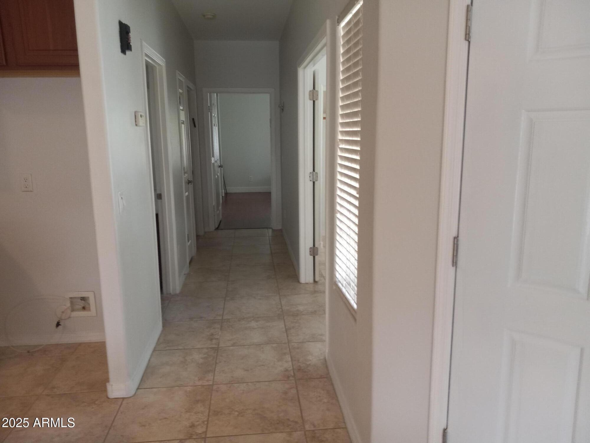 3947 West Roundabout Circle Chandler, AZ 85226 - Photo 17 of 32 a view of a hallway with a bathroom