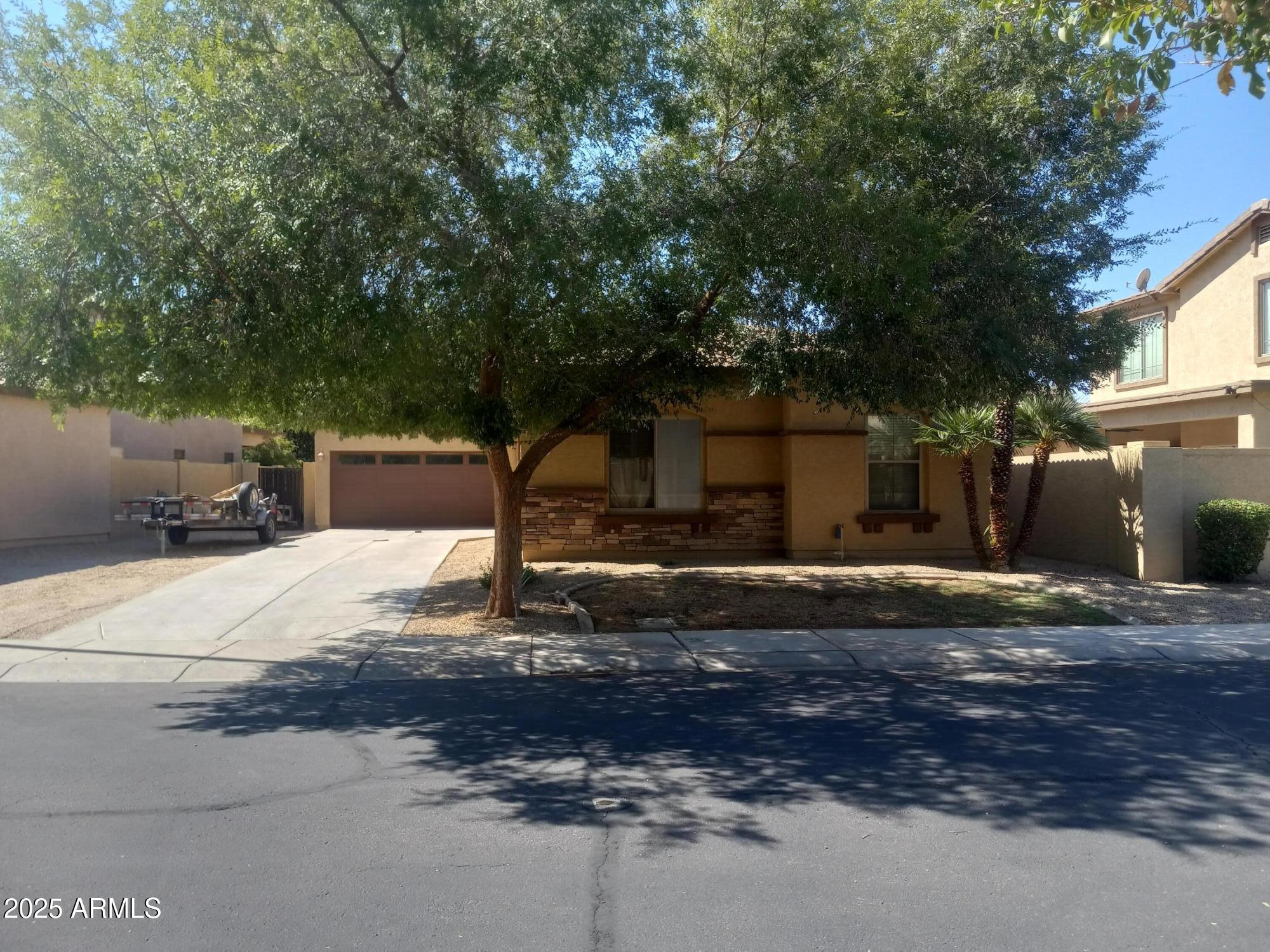 3947 West Roundabout Circle Chandler, AZ 85226 - Photo 2 of 32 a backyard of a house with trees