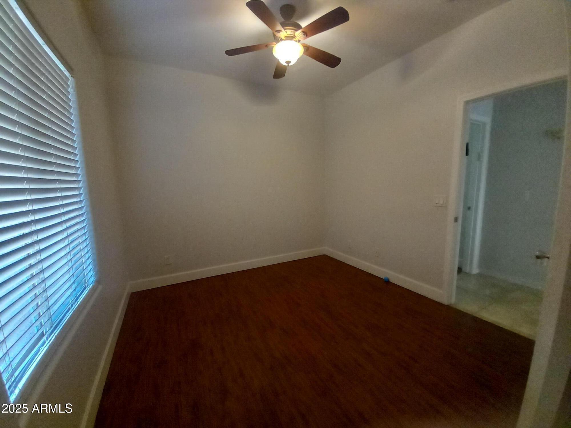 3947 West Roundabout Circle Chandler, AZ 85226 - Photo 24 of 32 wooden floor in an empty room with a window