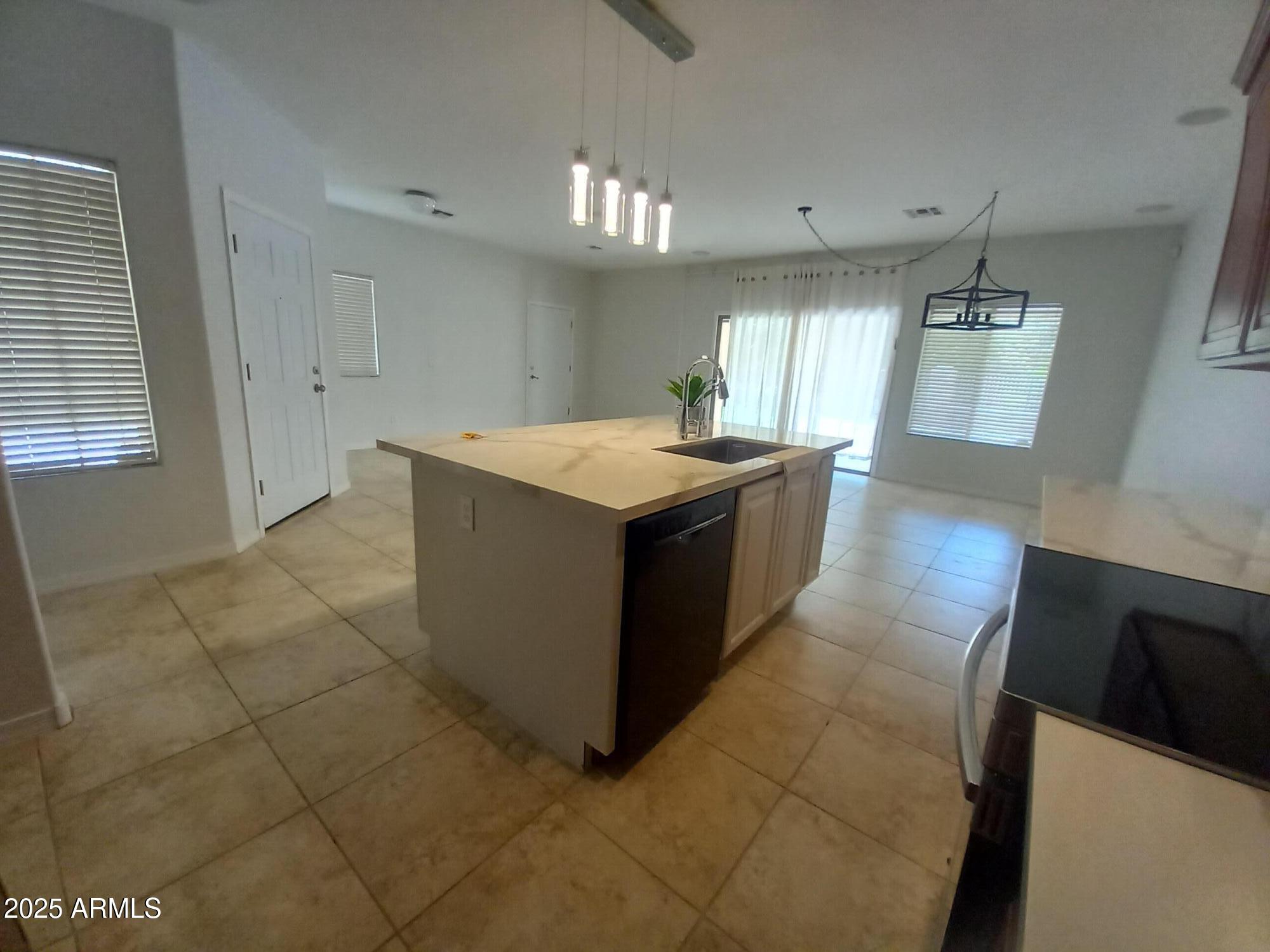 3947 West Roundabout Circle Chandler, AZ 85226 - Photo 26 of 32 a kitchen with stainless steel appliances granite countertop a sink and a stove