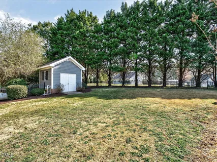 a front view of house with yard and trees