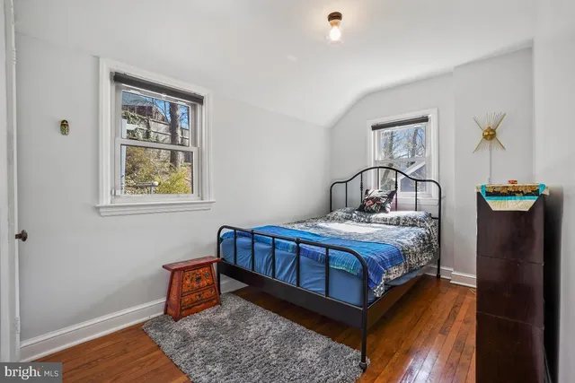 a bed sitting in a bedroom next to a window