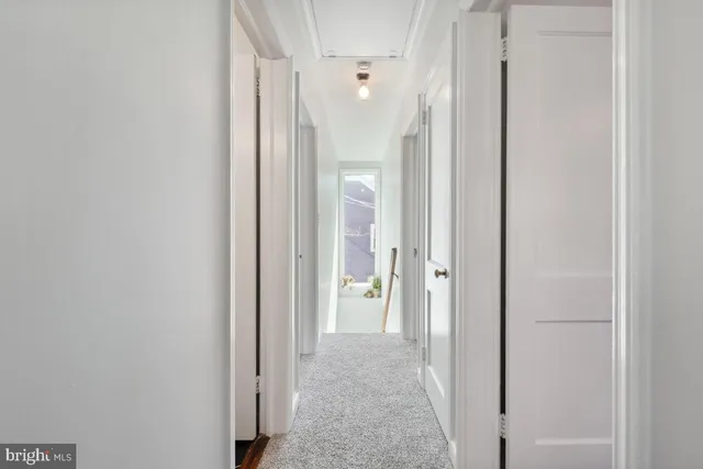 a view of a hallway with wooden shelves