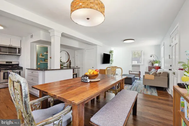a dining room with furniture and wooden floor