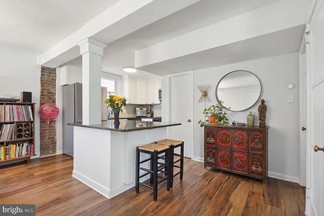 a kitchen with wooden floors and cabinets