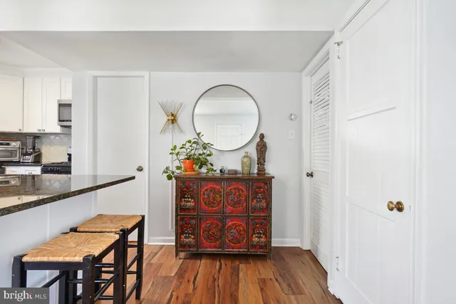 a view of a hallway with entryway wooden floor and front door