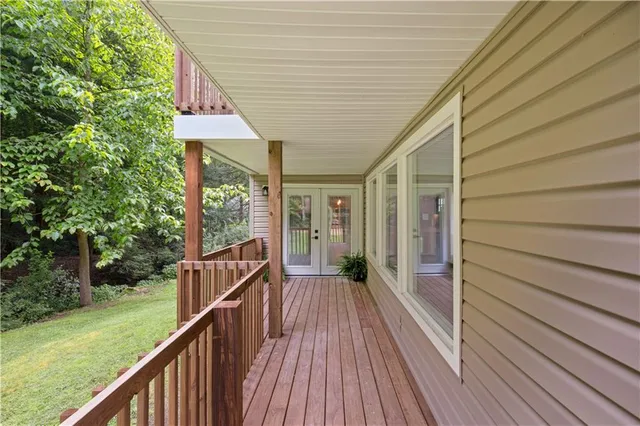 a view of balcony with wooden floor and fence