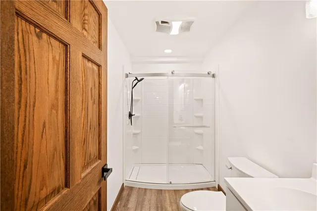 a bathroom with a shower and a toilet