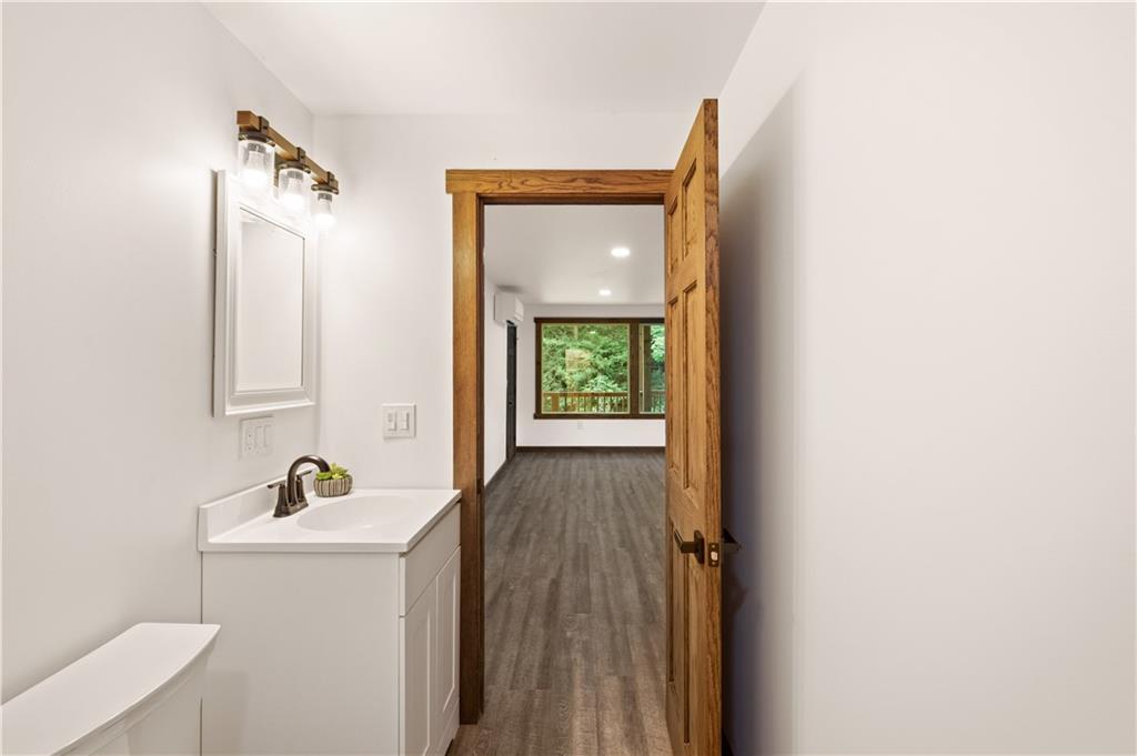 480 Freeman Falls Road Acme, PA 15610 - Photo 20 of 43 a bathroom with a sink a mirror and a toilet