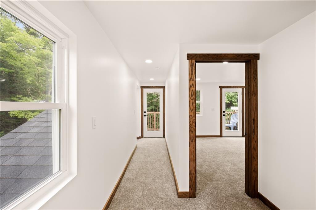 480 Freeman Falls Road Acme, PA 15610 - Photo 24 of 43 a view of a hallway with wooden floor and a living room