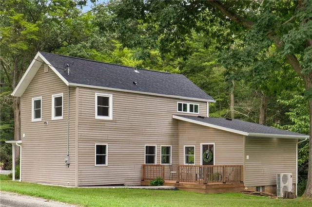 a house that has a tree in front of the house