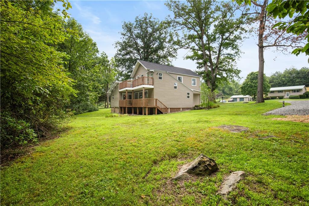 480 Freeman Falls Road Acme, PA 15610 - Photo 36 of 43 a view of a house with pool and a yard