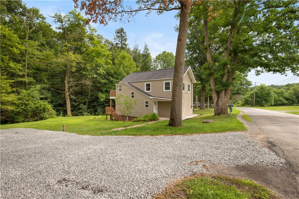 480 Freeman Falls Road Acme, PA 15610 - Photo 38 of 43 a view of a big house with a big yard and large trees