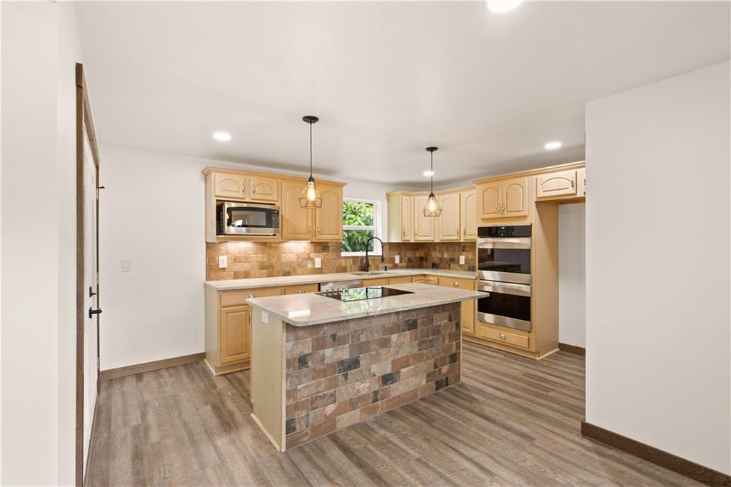 480 Freeman Falls Road Acme, PA 15610 - Photo 9 of 43 a kitchen with stainless steel appliances granite countertop a stove and a refrigerator