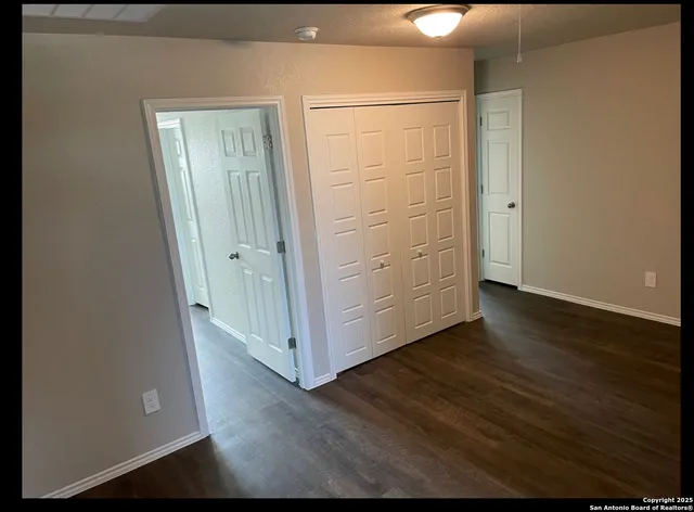 an empty room with wooden floor