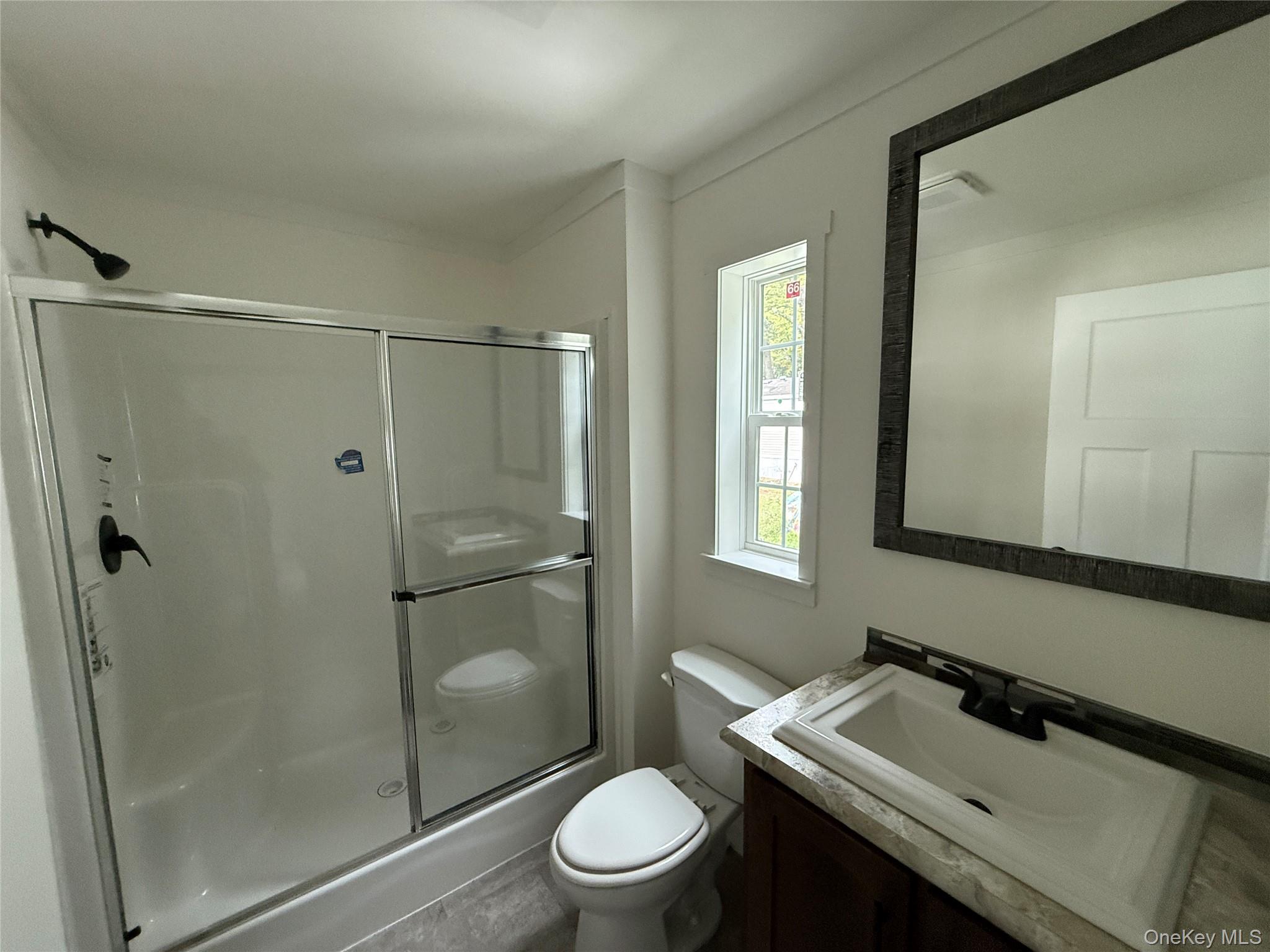 128 Forest Park Wallkill, NY 12589 - Photo 18 of 19 a bathroom with a sink toilet and shower