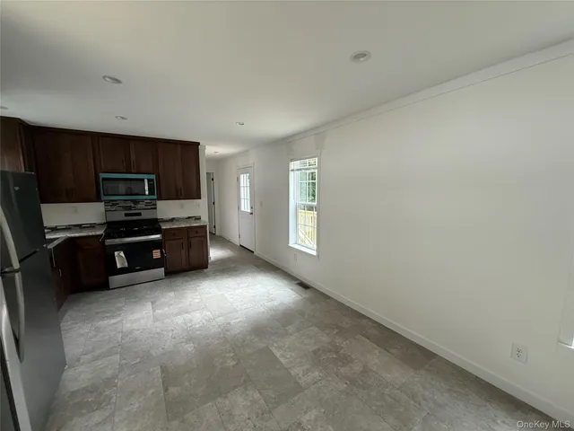 a kitchen with stainless steel appliances a refrigerator and a stove top oven