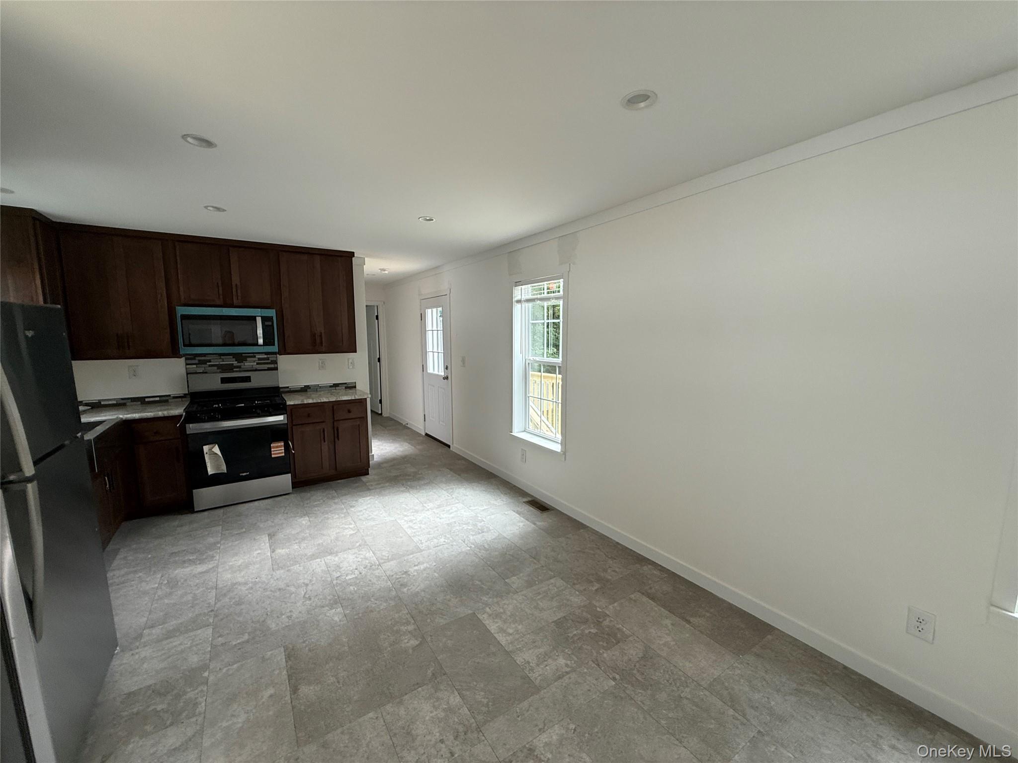 128 Forest Park Wallkill, NY 12589 - Photo 5 of 19 a kitchen with stainless steel appliances a refrigerator and a stove top oven