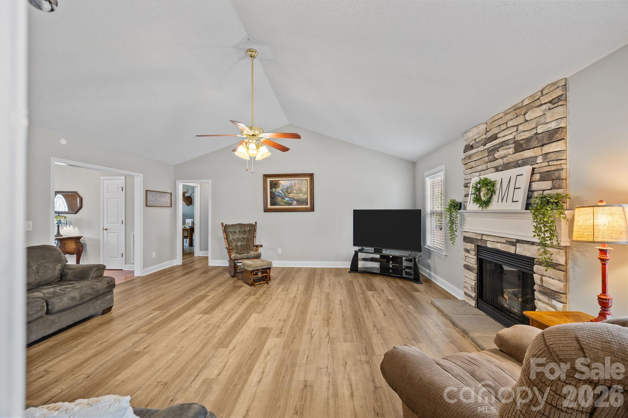 1749 Sells Road Salisbury, NC 28144 - Photo 11 of 47 a living room with furniture a fireplace and a flat screen tv