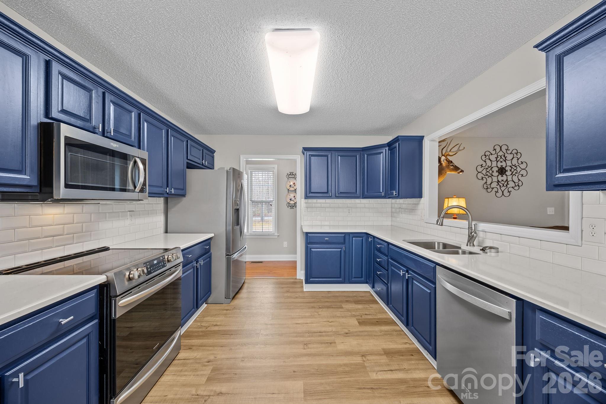 1749 Sells Road Salisbury, NC 28144 - Photo 15 of 47 a kitchen with stainless steel appliances granite countertop wooden cabinets a sink dishwasher a stove and a oven