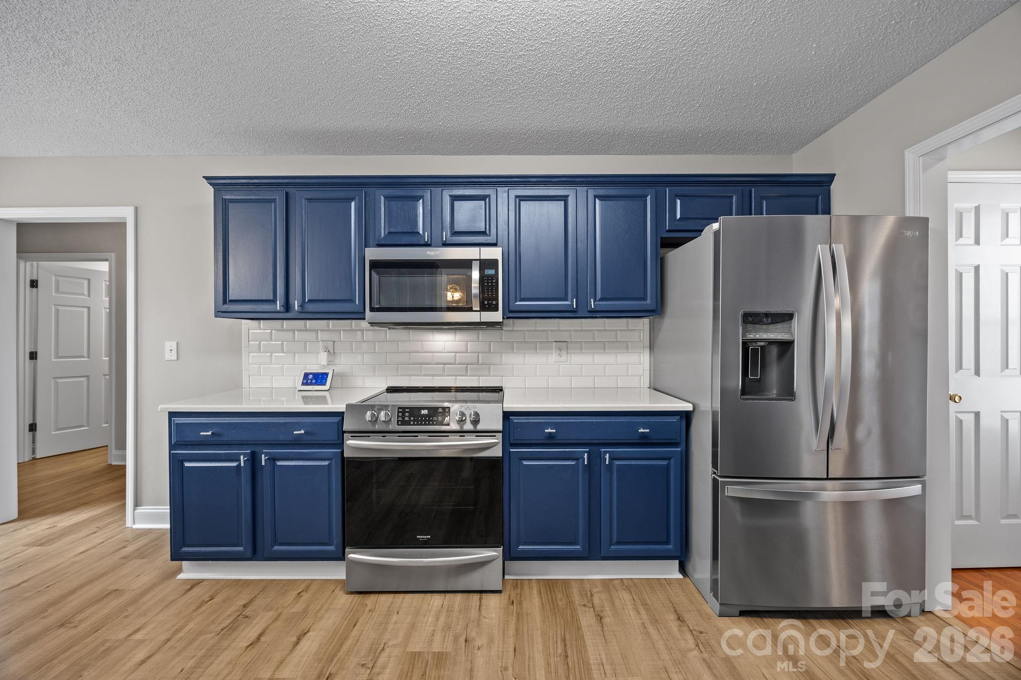 1749 Sells Road Salisbury, NC 28144 - Photo 17 of 47 a kitchen with stainless steel appliances granite countertop a refrigerator and a stove top oven