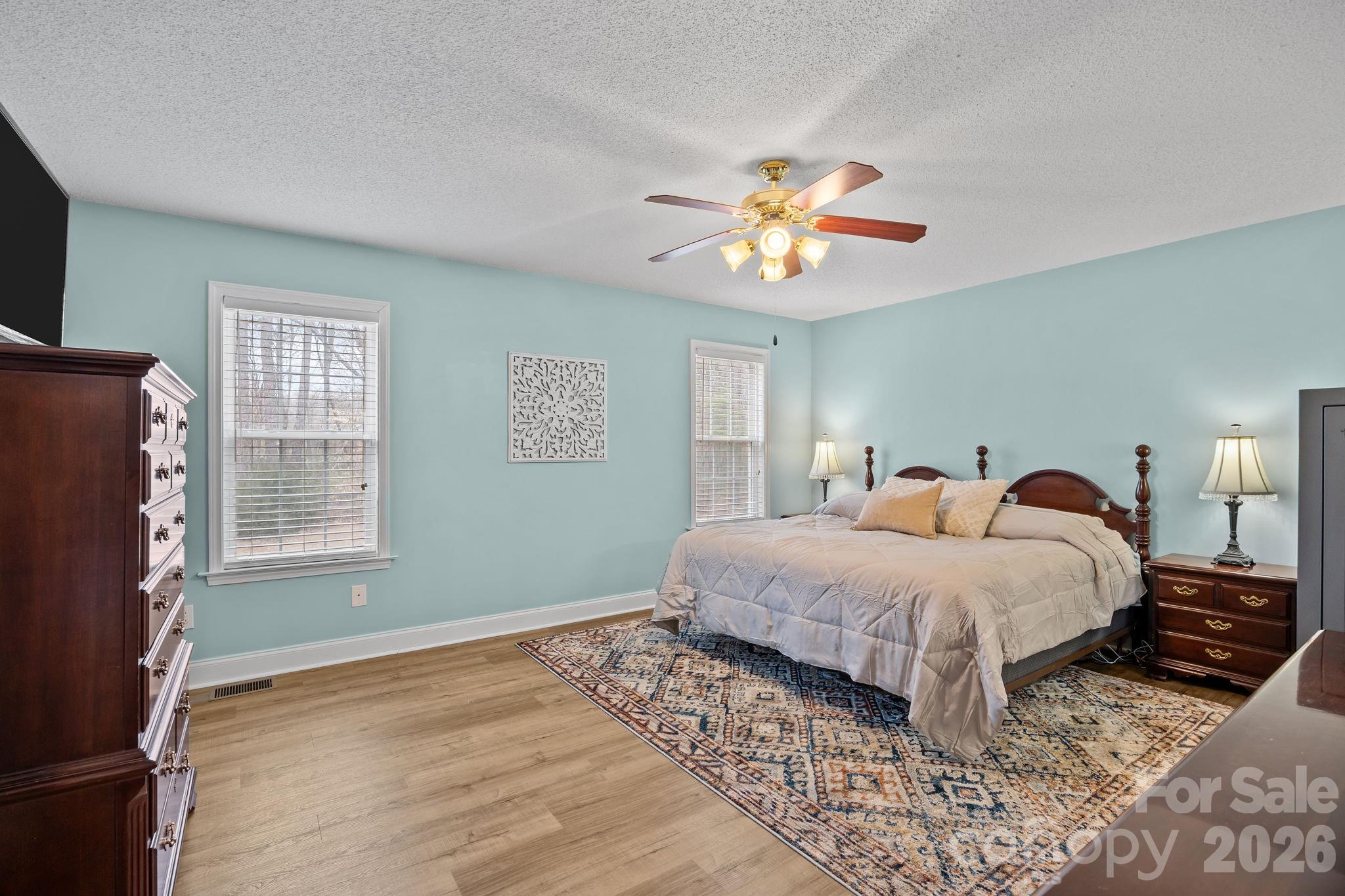 1749 Sells Road Salisbury, NC 28144 - Photo 19 of 47 a spacious bedroom with a bed and a chandelier