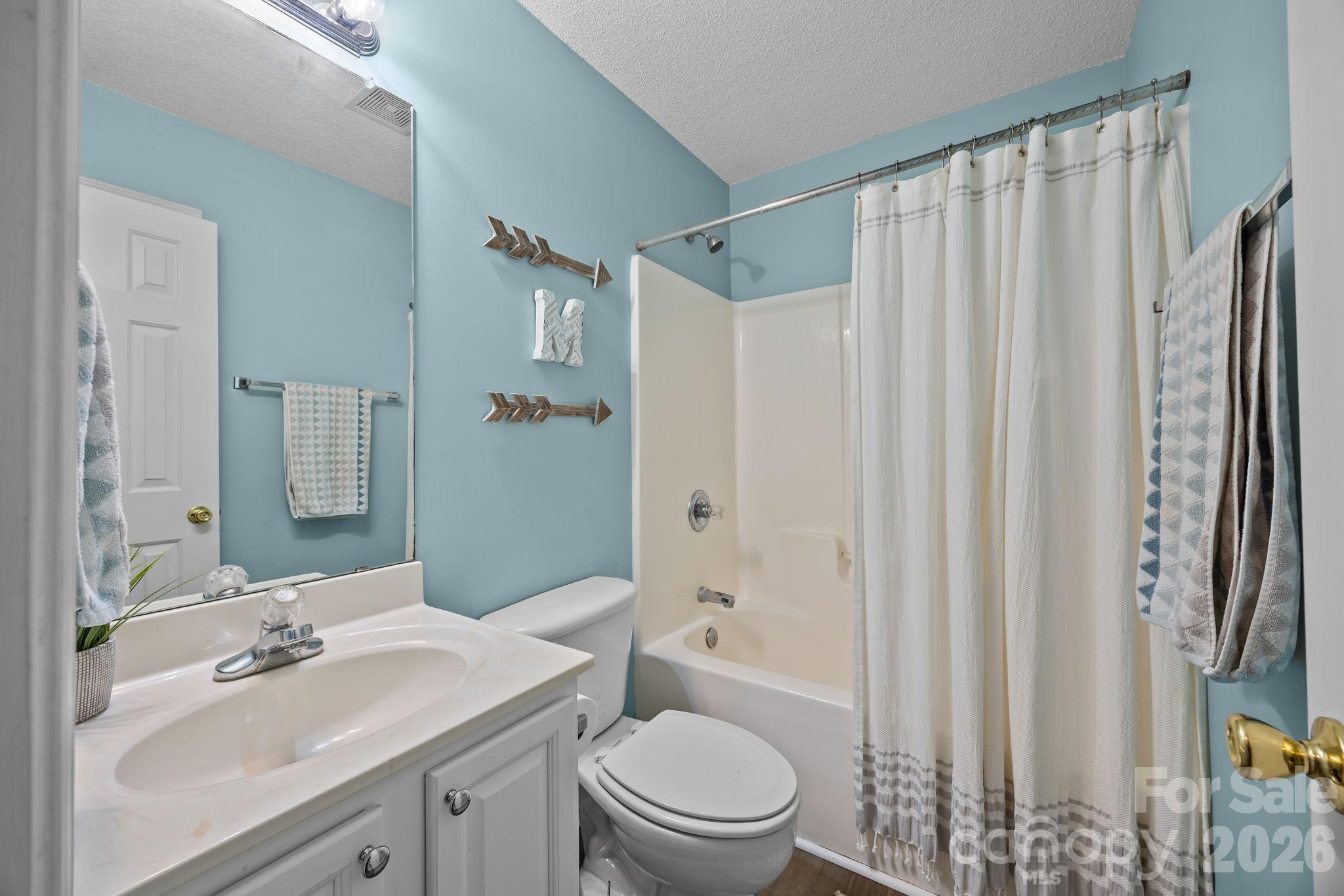1749 Sells Road Salisbury, NC 28144 - Photo 24 of 47 a bathroom with a sink a toilet and shower curtain