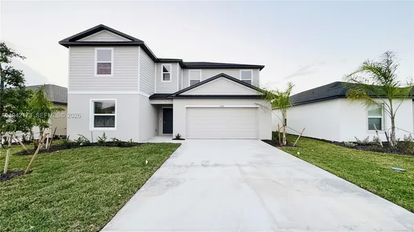 a front view of a house with a yard and garage