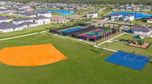 an aerial view of residential houses with outdoor space and pool