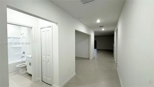a view of a hallway with toilet