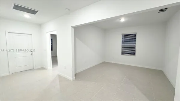 an empty room with a empty space and windows