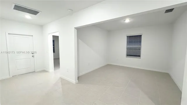 an empty room with a empty space and windows