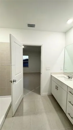 a bathroom with a granite countertop sink a toilet and bathtub