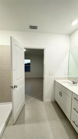 a bathroom with a granite countertop sink a toilet and bathtub