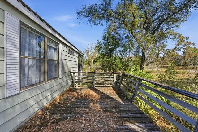 a view of a yard with wooden fence