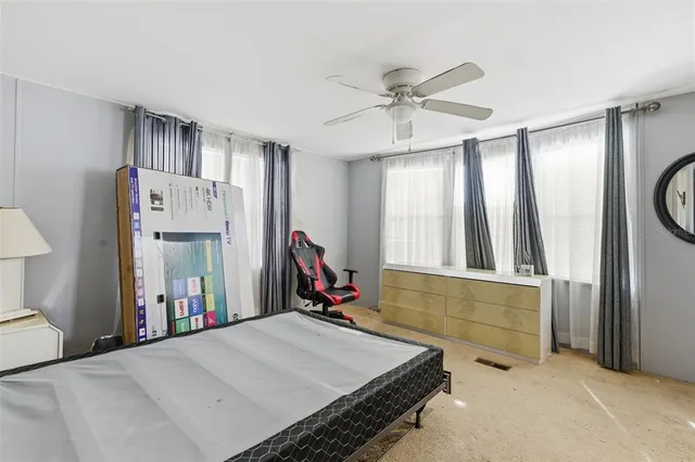 a bed room with a bed mirror and a window