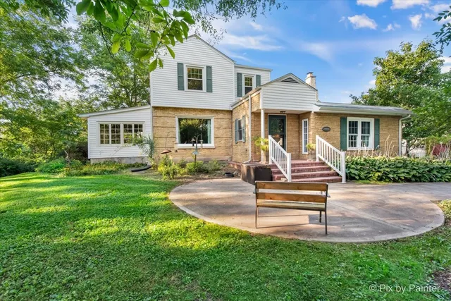 a front view of a multi story building with yard