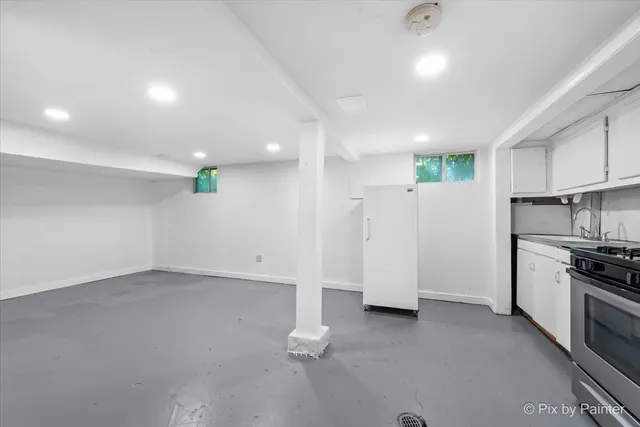 a large kitchen with stainless steel appliances granite countertop a stove and a sink with cabinets