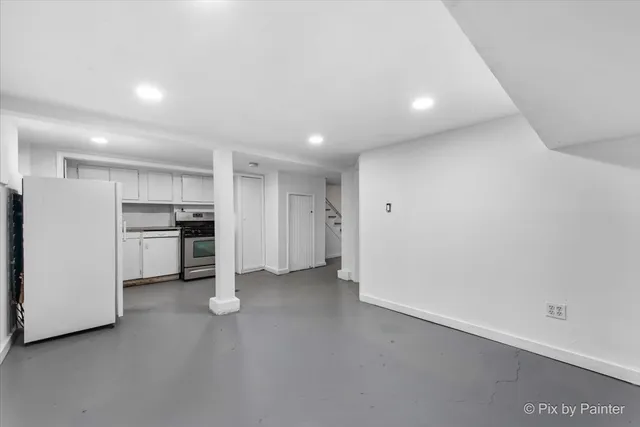 a very nice looking room with a chair and a flat tv screen