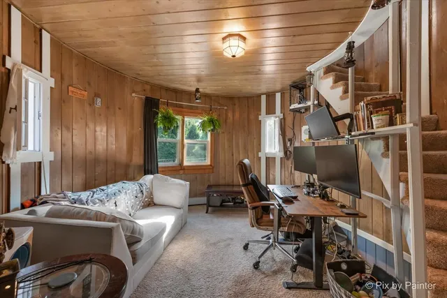 a aerial view of a house with a yard and large trees