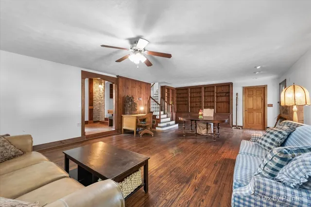 a living room with furniture a fireplace and a window
