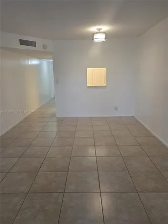 a view of an empty room with a bathroom