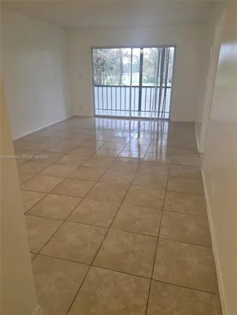 a view of an empty room and a window