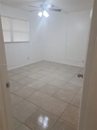 a view of a room with white walls and tiles