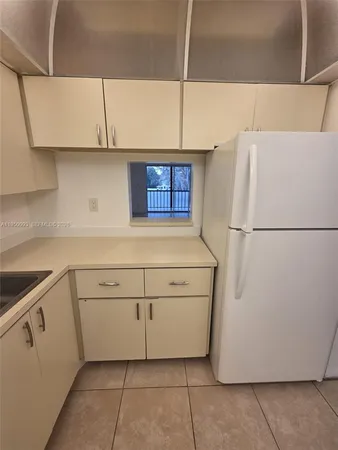 a white refrigerator freezer sitting inside of a kitchen