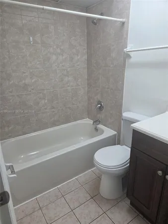 a bathroom with a toilet and a bath tub