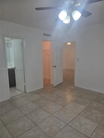 an empty room with a empty space and chandelier fan