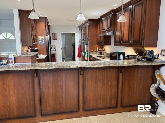 7310 Cook Road Foley, AL 36535 - Photo 11 of 14 Kitchen with hanging light fixtures, light stone countertops, a breakfast bar area, a peninsula, and recessed lighting